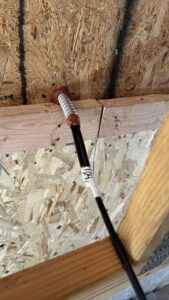 Electrical cable passing through a fire-sealed opening in framing