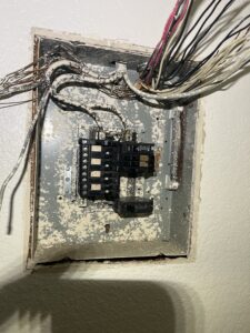 Existing apartment electrical panel with exposed circuit conductors