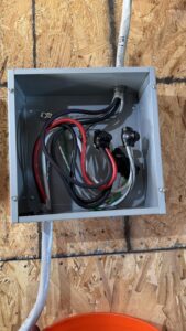 Covered electrical junction boxes labeled for apartment units