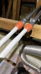 Electrical conductors passing through conduit sleeves with red fire sealant