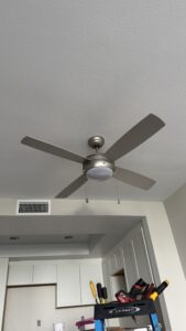 Ceiling fan installed above renovated apartment kitchen