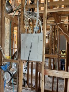 Electrical panel and circuit wiring installed in exposed wall framing