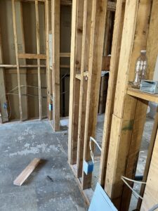 Electrical wiring and device boxes in exposed apartment wall framing
