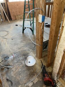 Electrical rough-in wiring and junction box beside apartment wall studs